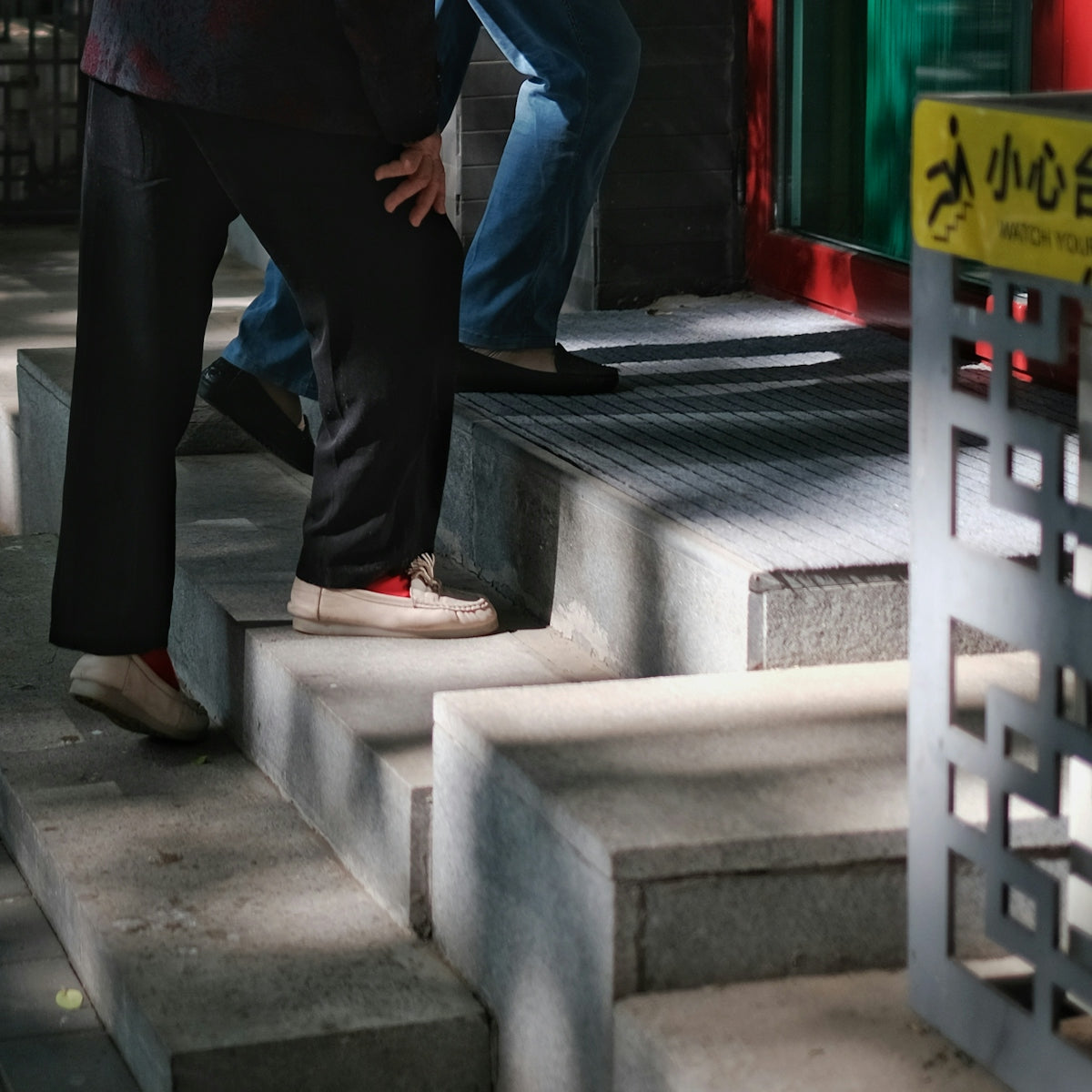 a man standing on a step next to another man