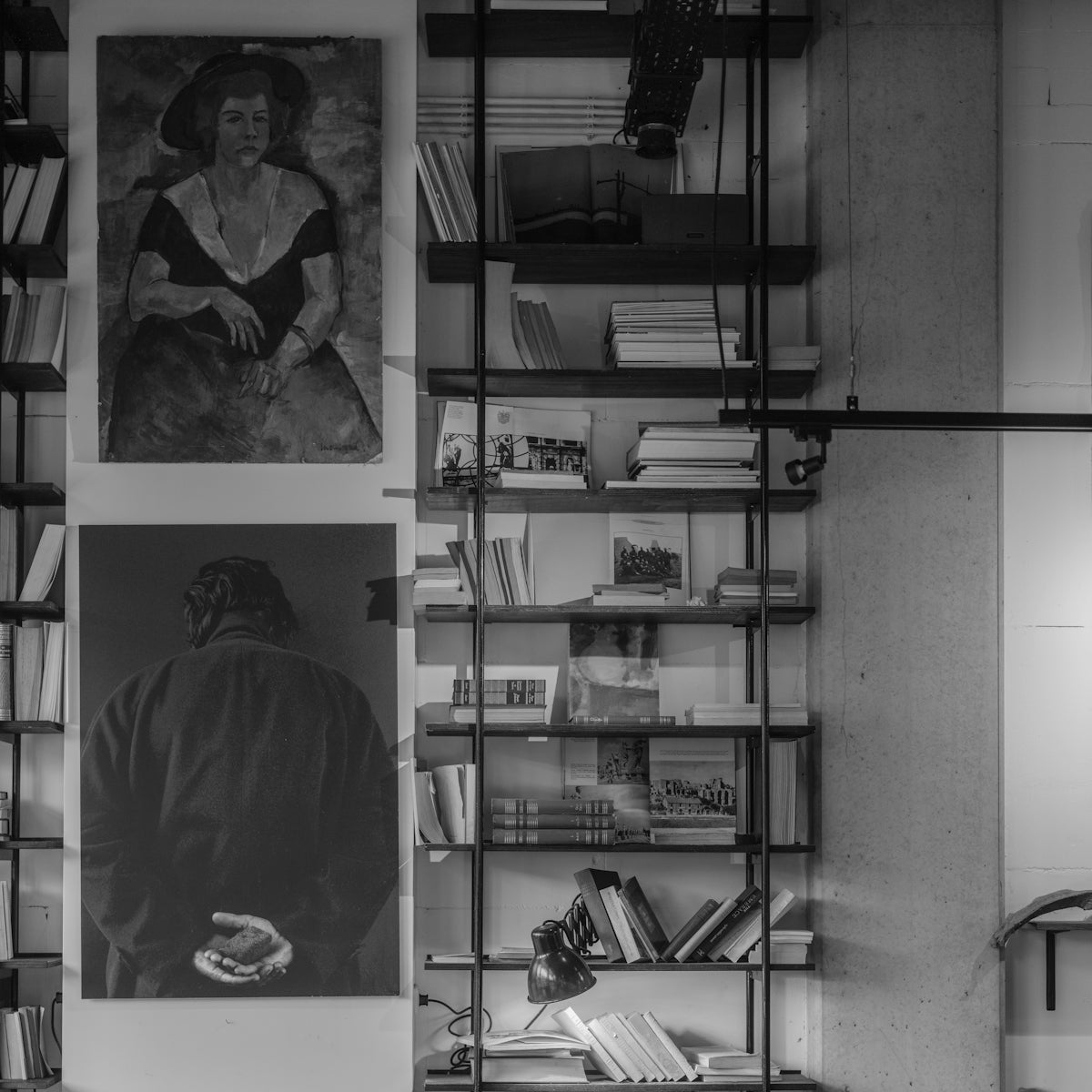 Bookshelves with paintings and various books.