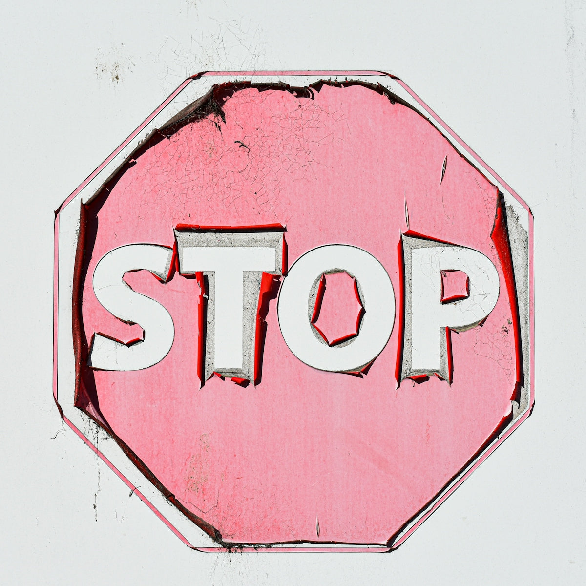 Pink stop sign with white letters