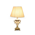 Pair of cream-colored table lamps with beige fabric shades and ornate gold bases.