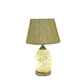 Glass table lamp with intricate bubble texture and beige fabric shade, lit on wooden base.