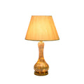 Table lamp with marbled beige ceramic base and warm beige fabric shade.
