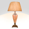 Pair of Viaga table lamps with pink glass bases and beige fabric shades on ornate bronze bases.